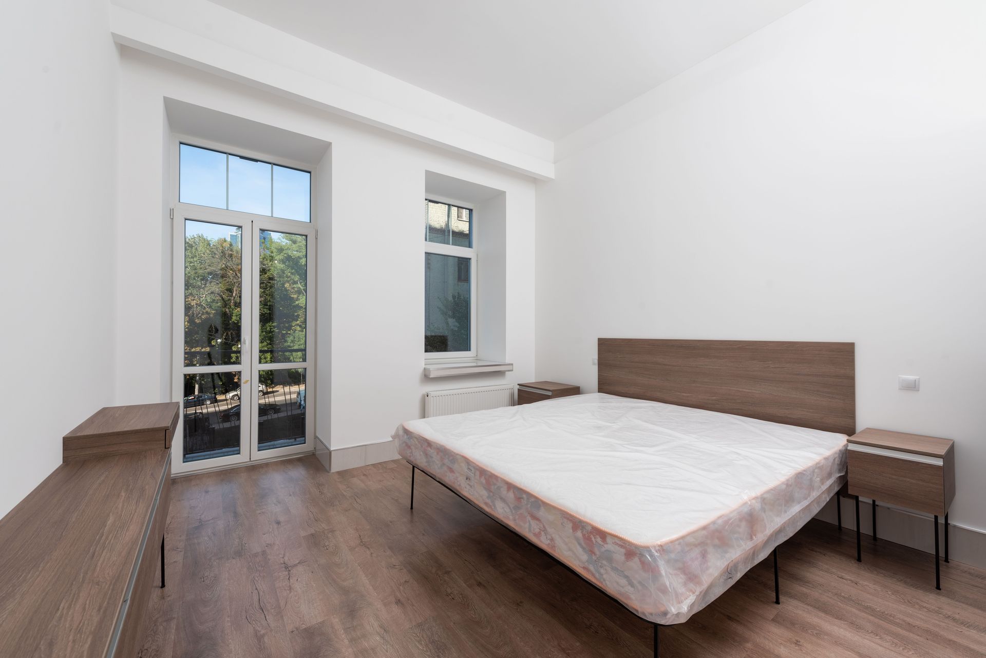 Bright and minimalist bedroom featuring a modern design with natural light from window.